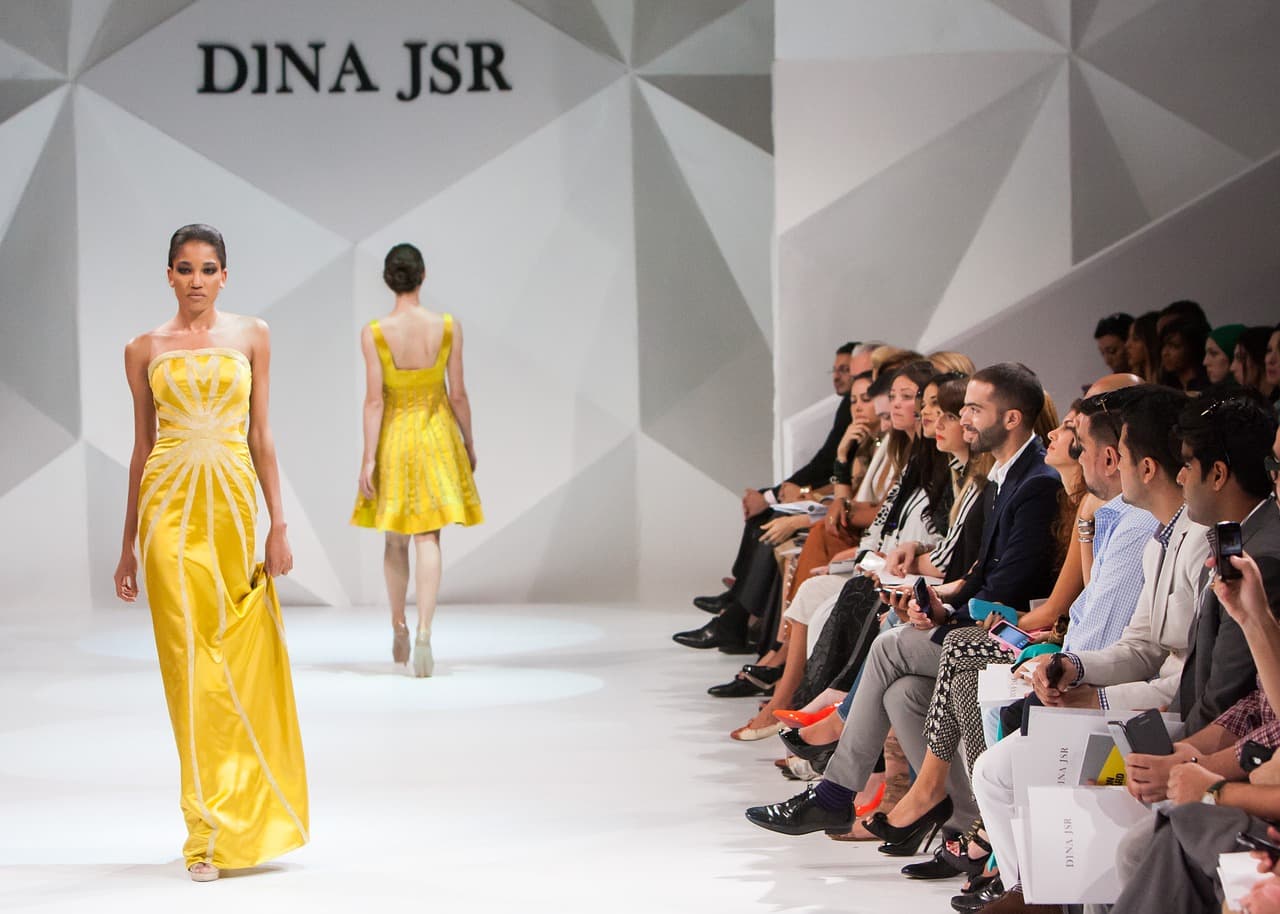 Yellow runway look on the catwalk shared by Caitlin Craig Lawrence